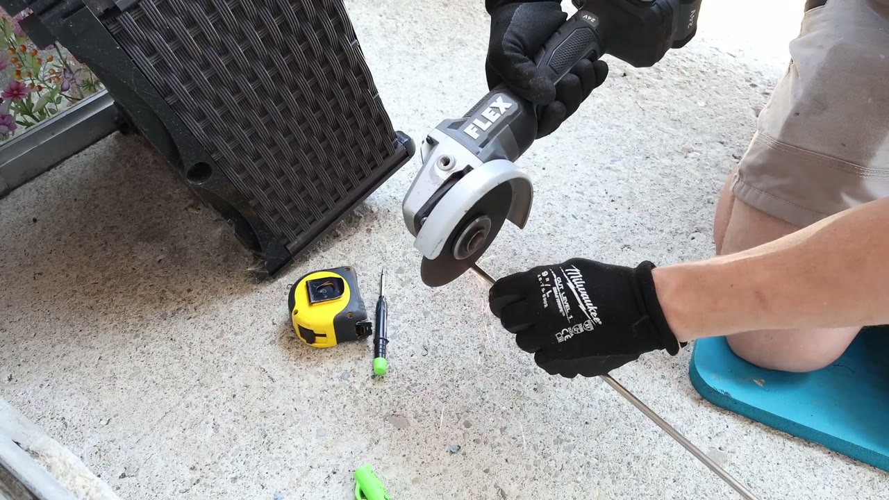 Cut-off wheel trimming the stainless steel track cap to the measured length