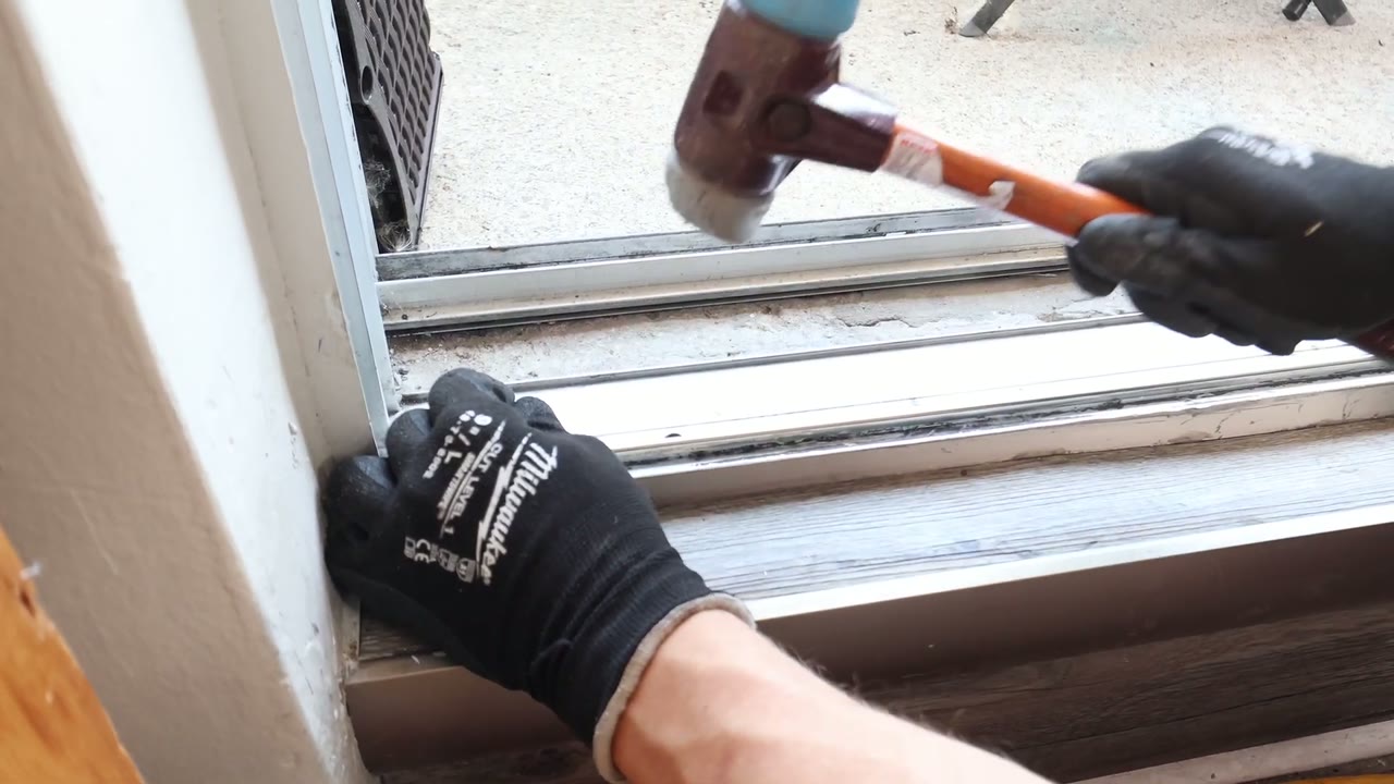 Rubber mallet tapping the stainless track cap onto the repaired rail