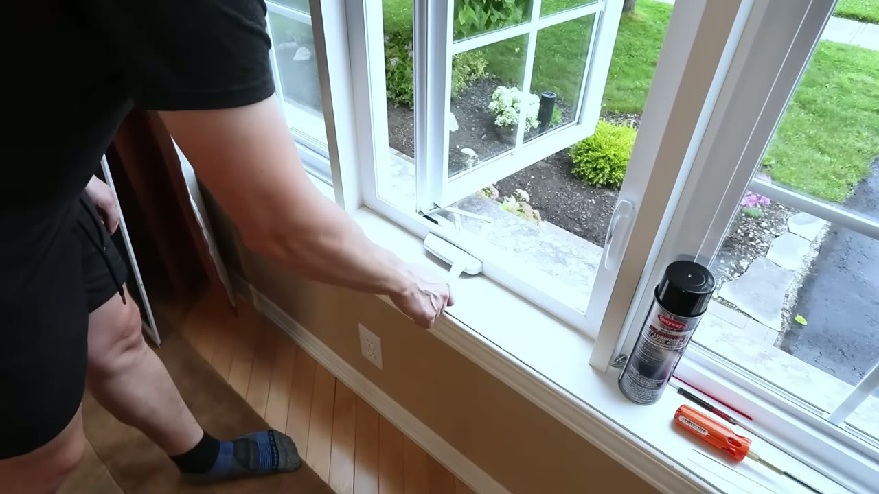Cranking the casement sash open to a full 90° for working room at the sill