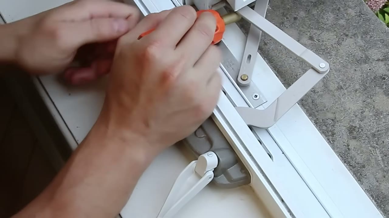 Cranking the loose handle to line the link arm up over its stud bracket
