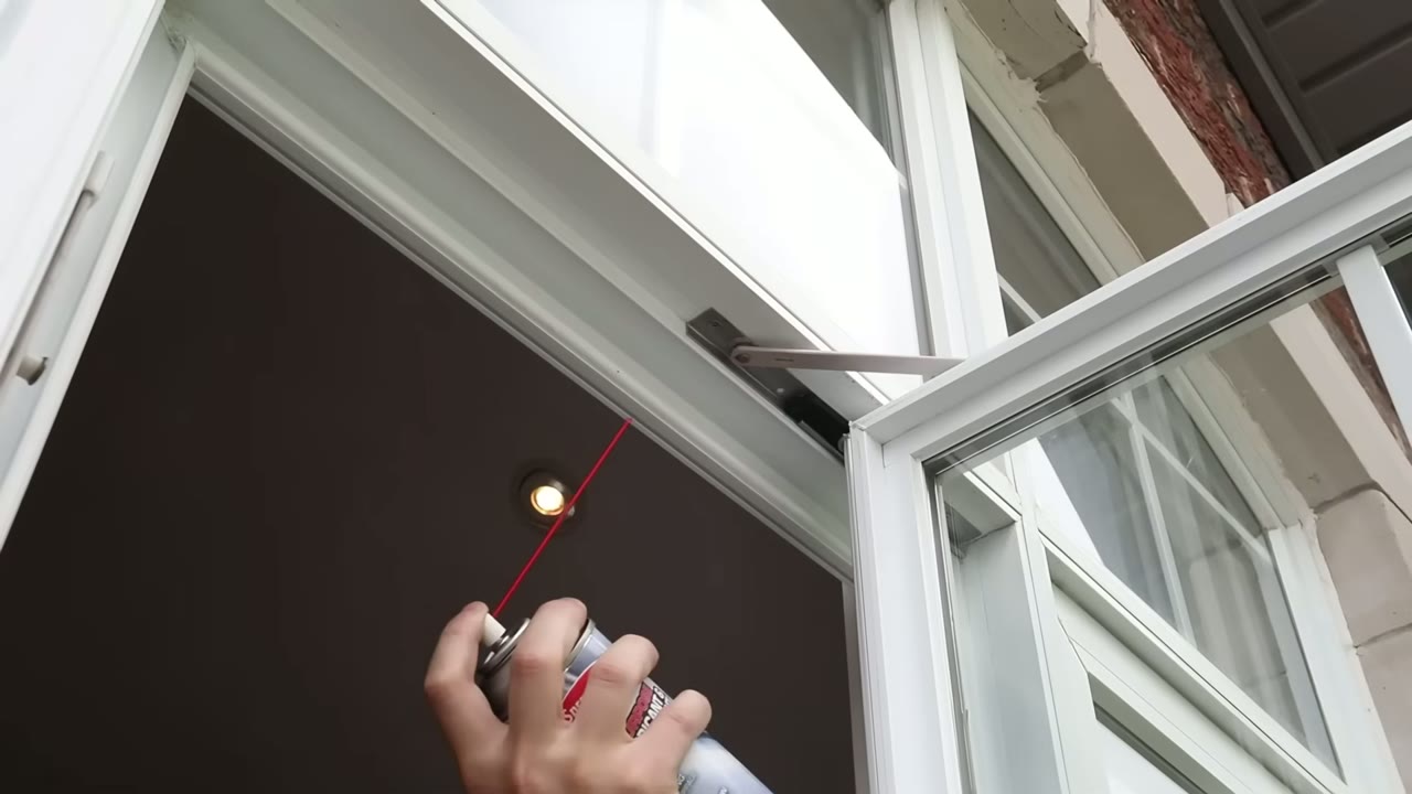 Spraying the upper casement hinge with lubricant before closing the window