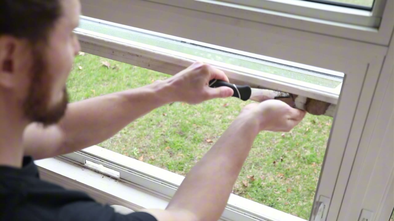 Scraping years of grit off the sash top before the new hardware goes in