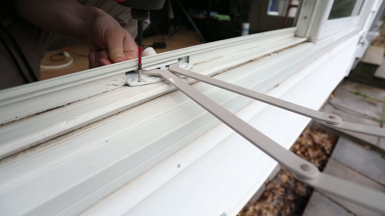 New white roto gear operator screwed down in the sill channel, scissor arms swung out