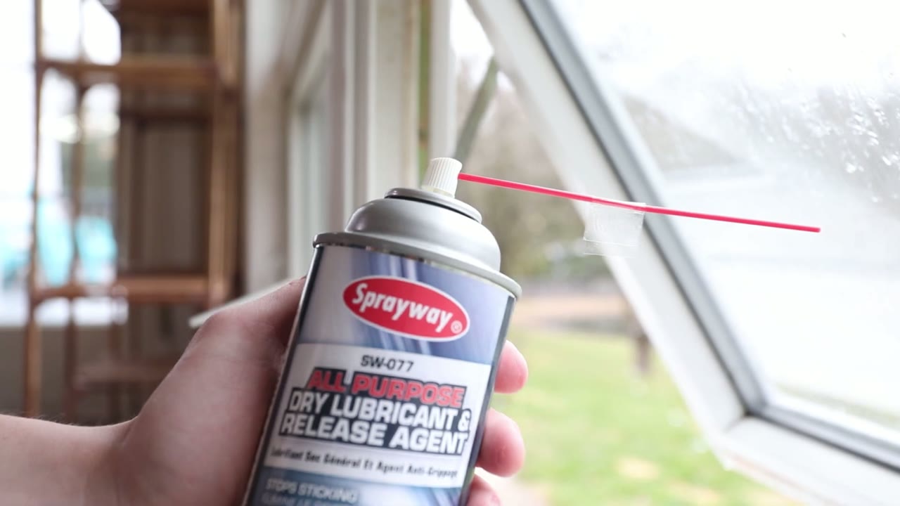 Sprayway dry-film lubricant going onto the hinge and arm pivots before the first full cycles