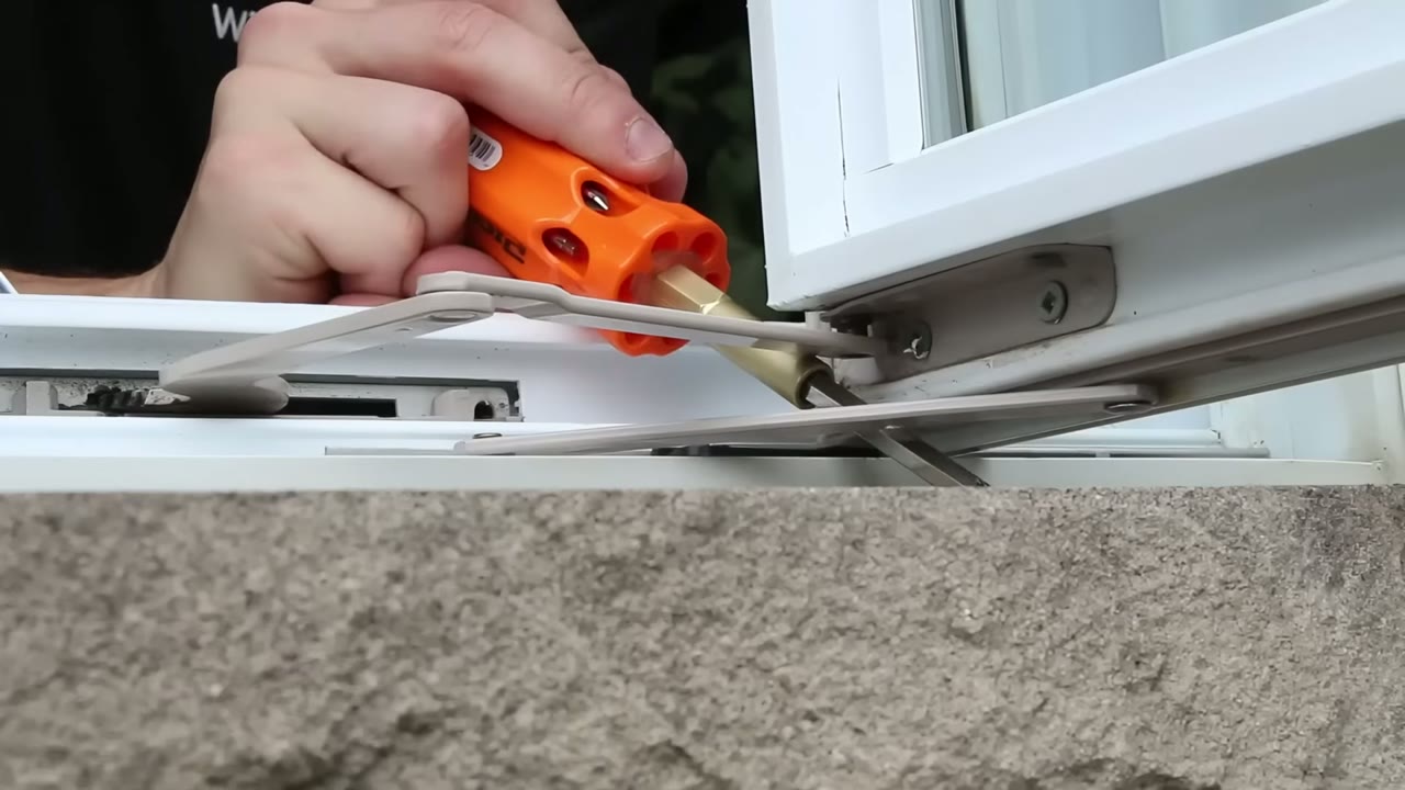 Operator link arm pressed home onto its stud bracket with the flathead for leverage