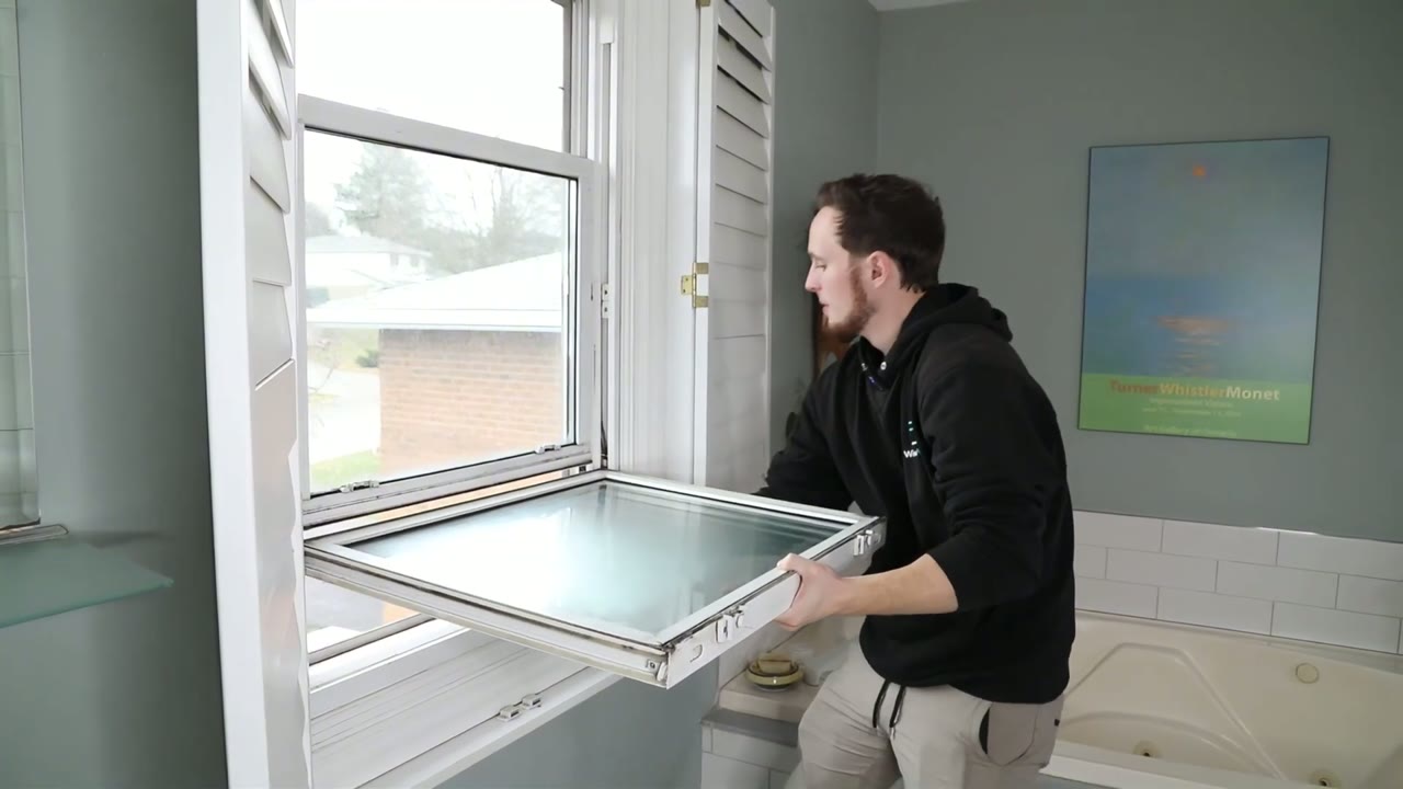 Lower sash tilted to 90° and lifted out of the frame one side at a time
